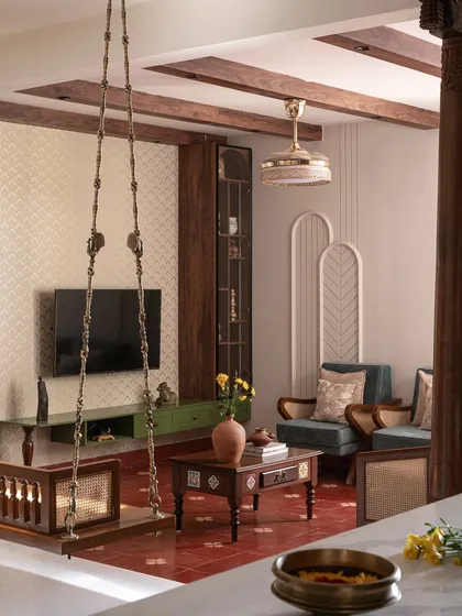 For this living room, I blended traditional Indian aesthetics with contemporary design. The space features antique wooden pillars, a classic swing, and rich textures to create a home that feels both rooted and innovative.