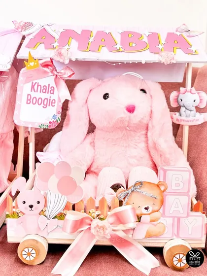 This carriage, personalized with the baby's name 'Anabia', features a large pink bunny and a 'Khala Boogie' sign, adding a lovely personal touch from the aunt.