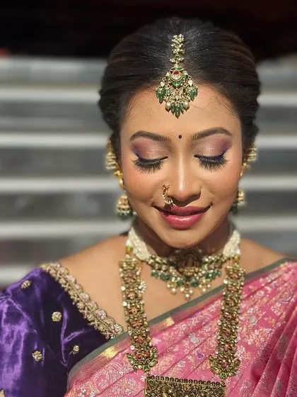 A close-up on the makeup, showing the soft purple and pink tones on her eyes.