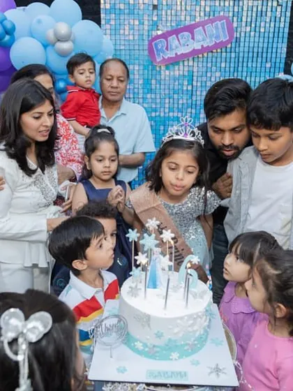 This is my favorite moment. The birthday girl, surrounded by her family and friends, making a wish and blowing out the candles on her Frozen themed cake. Creating these happy memories is why I do what I do.