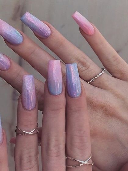 A dreamy dual-tone chrome effect on long, coffin-shaped nails. This set transitions from a soft pink to a light blue, all with a beautiful iridescent finish.