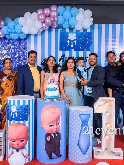 A happy family photo with a pastel blue and purple Boss Baby theme.