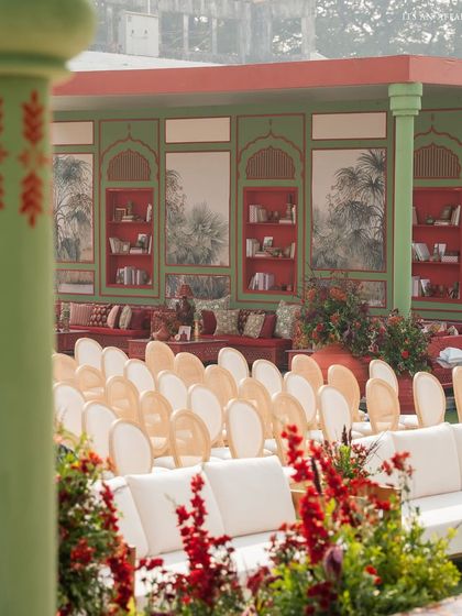 Guest seating with a view of the lounge area. The color palette of red, green, and cream is consistently used across all elements to create a cohesive and immersive experience.