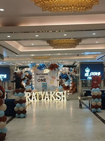 A wide shot of the banquet hall, showing the main stage and the teddy bear-themed pillars placed throughout the venue.