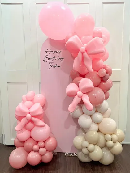 This coquette-themed setup showcases our skill in detailed balloon artistry. We hand-twisted multiple large and small pink bows and integrated them into an organic balloon garland, set against a custom pink arch backdrop for Trisha's birthday.