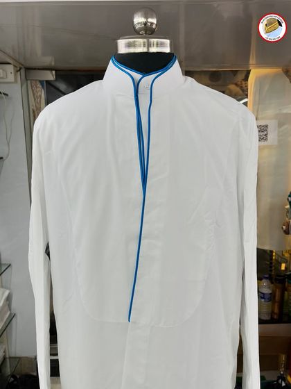 This white saya kurta features a bright blue piping, offering a bold and modern take on the traditional attire.