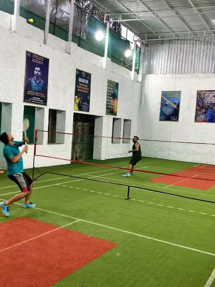 A player mid-air, executing a perfect jump smash during a singles practice session.