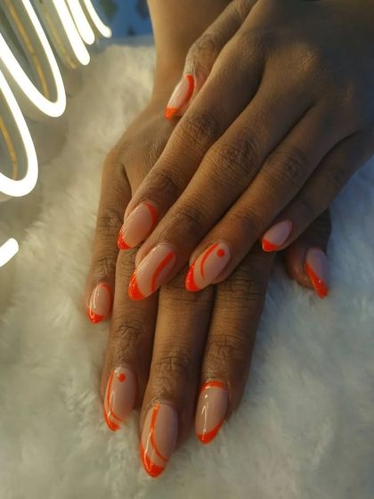 Some Saturday nail art inspiration. This design features a nude base with abstract lines and tips in a vibrant neon orange.