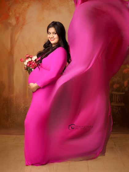 A dynamic and joyful shot with a flowing pink gown. The movement of the fabric adds energy and a touch of glamour to the portrait.