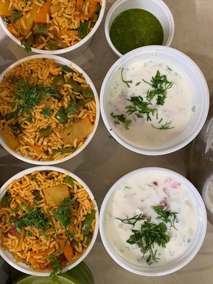 Bowls of Tawa Pulao and Raita, a perfect meal combination.