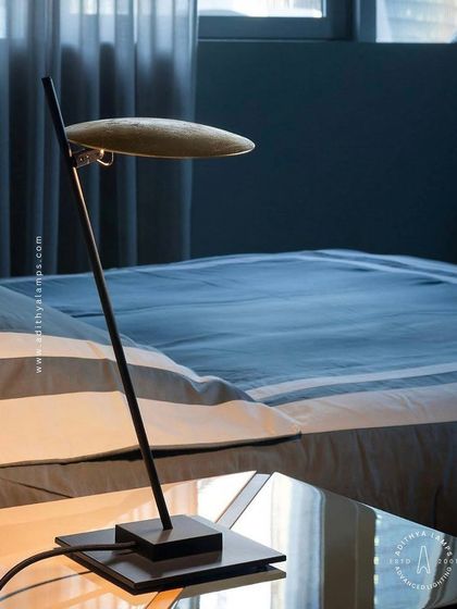 A showcase of our diverse modern table lamps. This selection includes a sleek adjustable reading lamp, a minimalist LED bar lamp, a smoked glass ambient light, and a glowing orb, demonstrating options for every style and need.