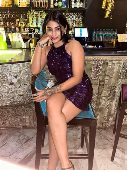 Posing at the bar in my birthday dress. The sequins catch the light beautifully, making it the perfect party outfit.