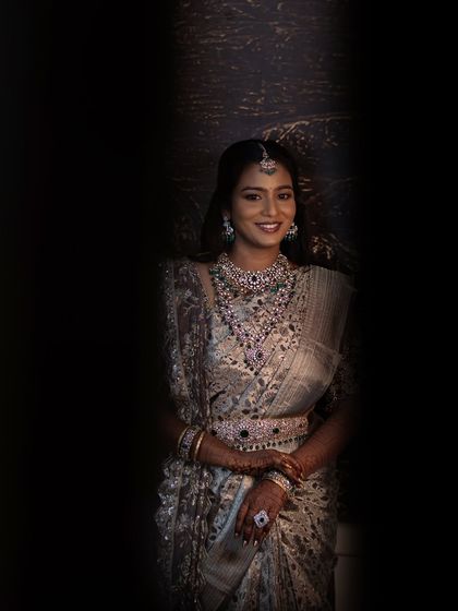 Another artistic shot of Sruthi, with a focus on her happy expression. The lighting and composition make this a unique and beautiful portrait.