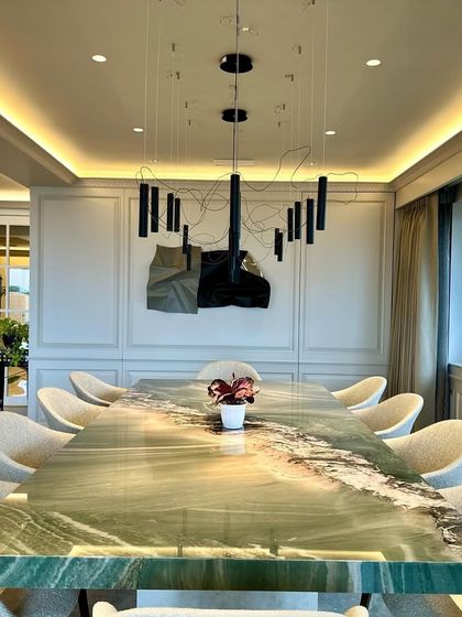 The reflection of the dining table on the polished floor doubles the beauty of the space.