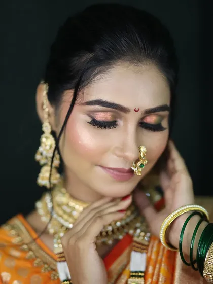 A detailed close-up of the eye makeup. I used a blend of peach and gold shimmer to create a soft yet festive look that complements the traditional attire.