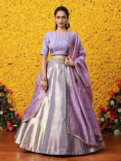 A beautiful lilac tissue lehenga with a matching embroidered blouse and organza dupatta. This soft, iridescent color is perfect for daytime celebrations.