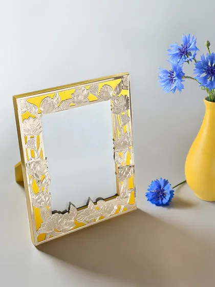 Stories deserve a frame as beautiful as the memories they hold. This frame features a vibrant yellow enamel border with silver-plated floral cutwork, adding a cheerful and artistic touch.