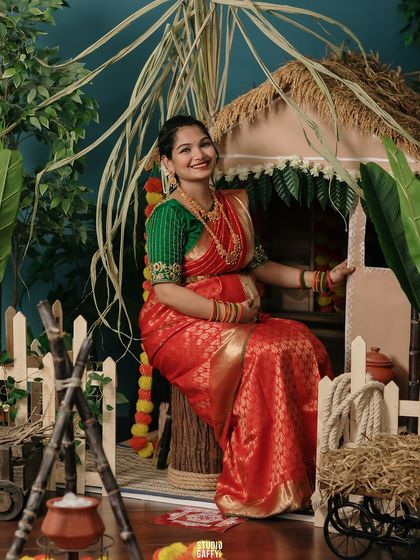 A joyful portrait of the mother-to-be seated in our festive Pongal-themed set.