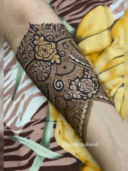A beautiful forearm design for engagement bride Ameena, featuring a mix of roses and geometric patterns.