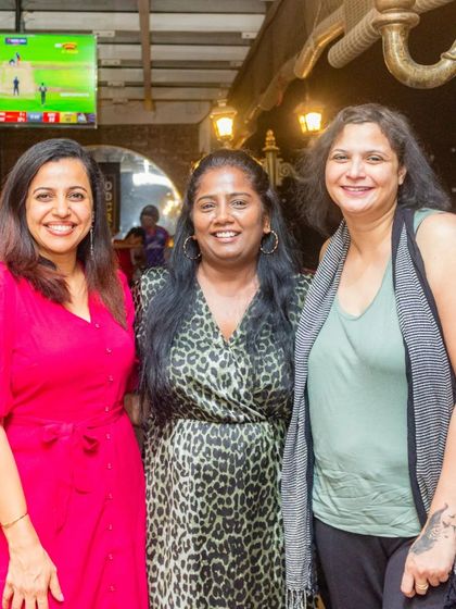 Friends getting together at the pub. You can see the glow of the live match screening in the background, which is a central part of the experience for many of my guests.