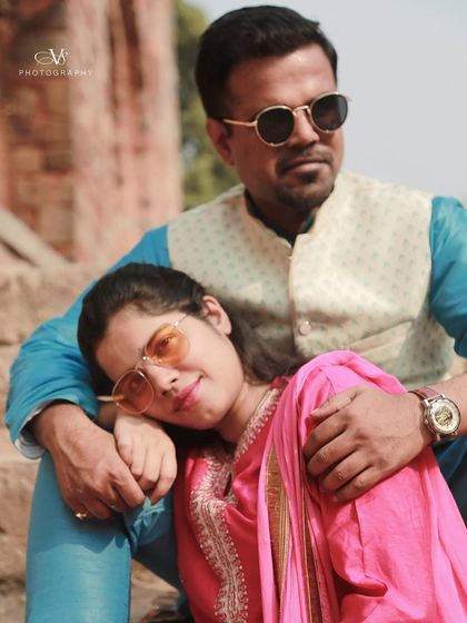 A close-up of the couple from their traditional pre-wedding shoot, highlighting their loving expressions and stylish sunglasses.