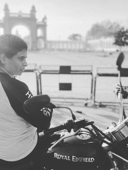 A black and white photo of a graduate in Mysore. The timeless look of the photo matches the classic appeal of the Royal Enfield.