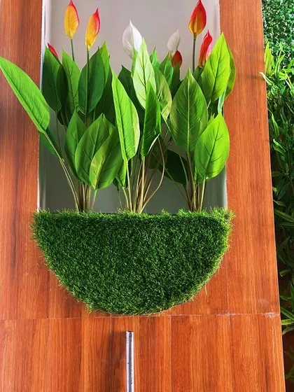 A different angle of the wall-mounted floral planter, showing its clean, semi-circular design. This is an ideal solution for adding greenery to tight spaces.
