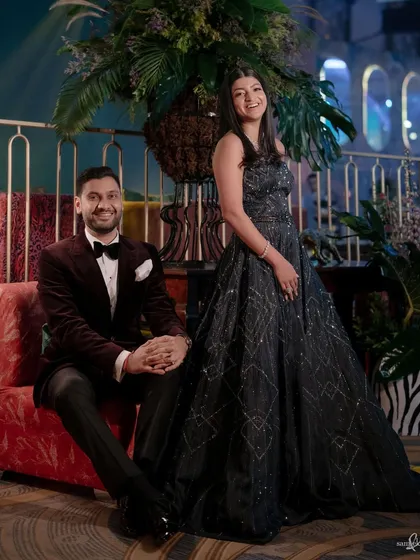 A classic portrait of Tanya and Shivam at their party. Their relaxed smiles and the beautifully decorated venue create an image of effortless elegance and happiness.