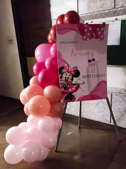 Welcome your guests in style. For this Minnie Mouse party, I created a custom welcome sign on an easel, complete with a matching balloon garland to set the theme right from the entrance.