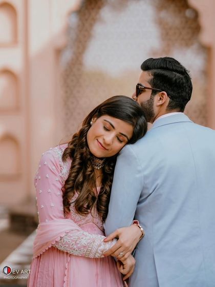 An intimate and tender moment. The makeup is soft and flawless, enhancing the romantic mood of the photograph.