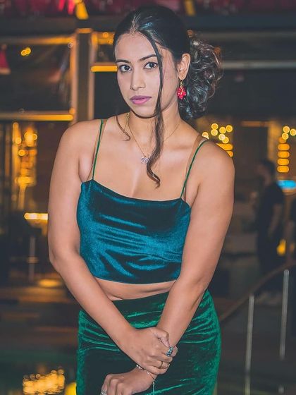 A guest in a festive green velvet outfit.