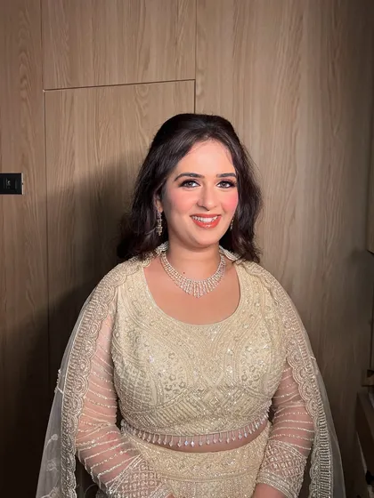 A smiling shot of this client, her makeup looking fresh and radiant for the party.
