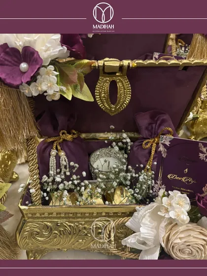 Here is the Rajwada Chest, a gift of timeless elegance fit for royalty. The deep purple velvet interior and ornate gold-finished exterior make it a truly luxurious wedding hamper.