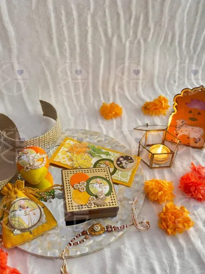 A flat-lay of one of my Rakhi gift sets. This arrangement on a mother-of-pearl tray includes a 'rakhi', a candle, and other small, beautifully coordinated items.