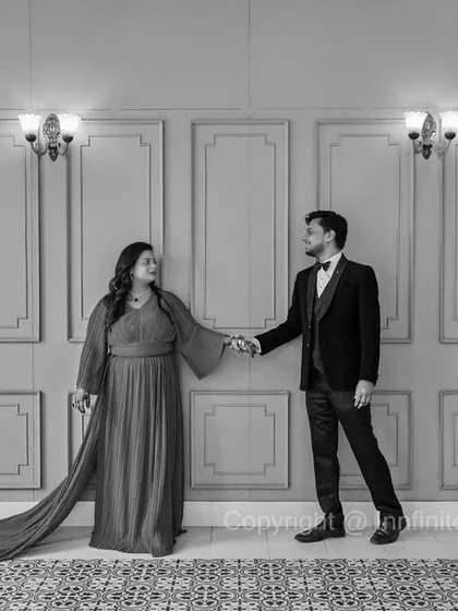 A simple yet elegant black and white shot in our studio, where the long trail of the gown adds a dramatic flair to a classic pose.