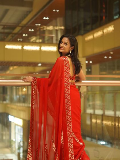 Another angle of the red 'Disco Diva' saree, showing the beautiful fall of the georgette fabric and the intricate sequin work on the border.