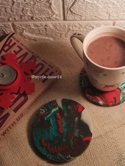 A cozy Christmas scene featuring our marbled coasters and a Snowflake T-light holder. We designed these coasters with a festive red and green marble effect, perfect for your cup of hot chocolate.