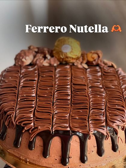 Our Ferrero Nutella cake is a crowd-pleaser. It's covered in a smooth Nutella frosting, a chocolate drip, and topped with Ferrero Rocher chocolates.