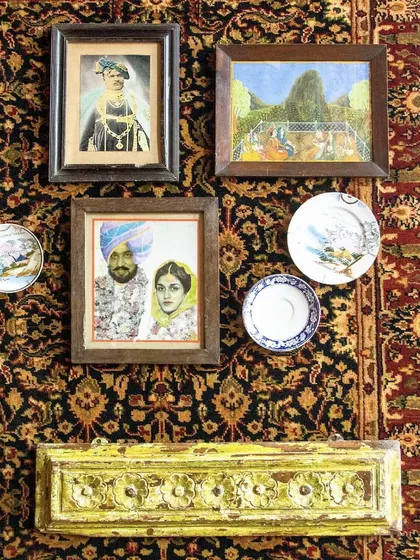 Every nook and cranny holds treasures. This wall arrangement, featuring portraits and antique plates against a Persian carpet, brings diverse traditions and stories together.