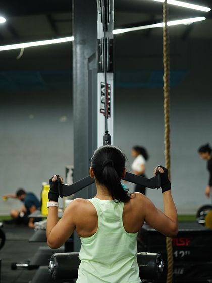 Developing a strong back with lat pulldowns. This exercise is key for improving posture and building that V-taper physique.