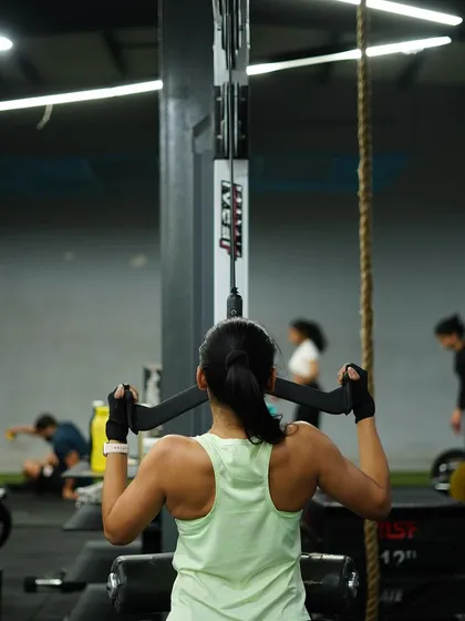 Developing a strong back with lat pulldowns. This exercise is key for improving posture and building that V-taper physique.