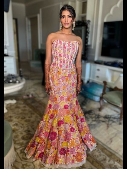 A stunning client ready for her haldi ceremony, her hair styled in a beautiful updo.