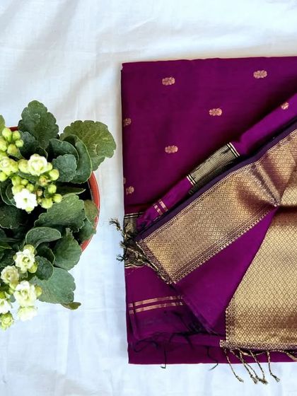 A beautiful purple Maheshwari saree with gold butti and a heavy zari pallu, perfect for grand occasions.