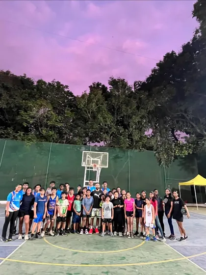The whole group gathered under a beautiful evening sky after an inspiring session. We focus on building a strong and supportive basketball community.
