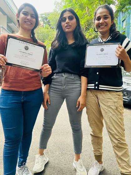 Three graduates proudly display their certificates. They are the newest members of the Heels on Wheels sisterhood.
