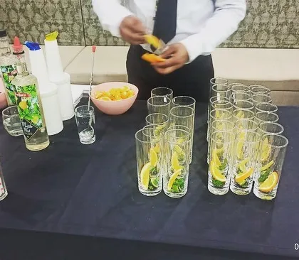 My bartenders preparing fresh garnishes like lemon and mint for the mocktail station. Fresh ingredients are key to making delicious drinks.