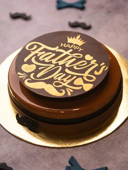 A special cake designed just for Father's Day. This coffee and chocolate creation has a rich, glossy finish and is topped with a custom "Happy Father's Day" chocolate plaque.