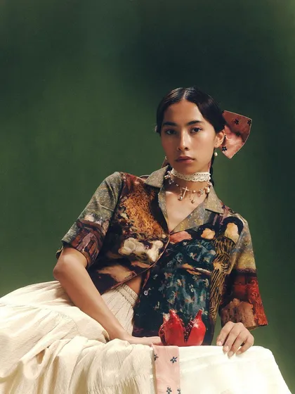 A beautifully styled shot from Cord's Summer '24 campaign, featuring a pomegranate prop that adds a pop of color and narrative.