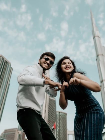 A fun and playful pose in front of the Burj Khalifa, capturing the couple's joyful energy.