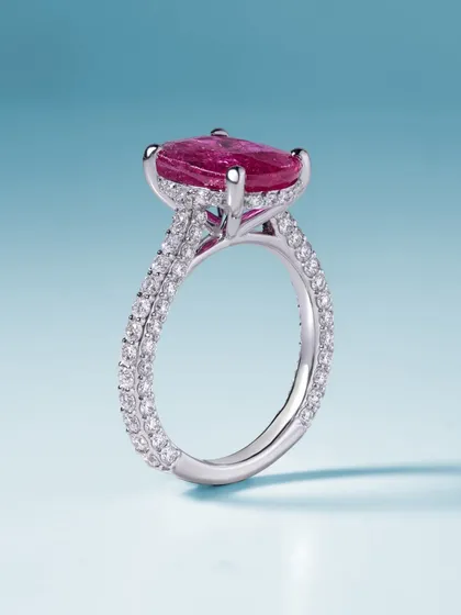 A side view of the passion-fueled ruby ring. This angle shows the delicate double-pavé band and the gallery that holds the magnificent gemstone, highlighting the intricate craftsmanship that goes into every piece.